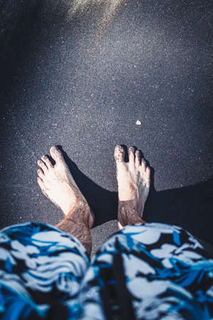 Feet on black sand beachの写真素材