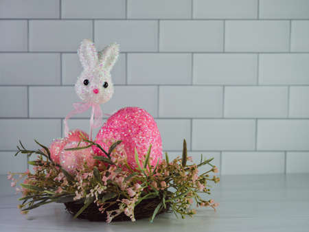 Easter bunny on a stick with a giant pink Easter egg and 3 smaller pink Easter eggs sitting in a...