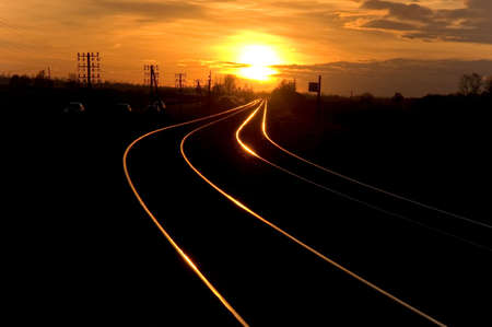 Railway with no electricity (gasol train) going to the sunsetの写真素材
