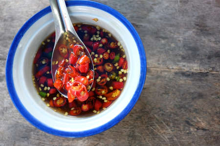 Chilli in fish sauce with spoonの写真素材