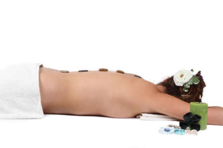 Young garl having hot stone therapyの写真素材