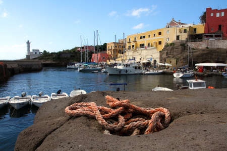 the port of Ventotene with houses and the lighthouseの写真素材