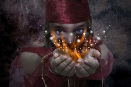 Young girl with magic handsの写真素材