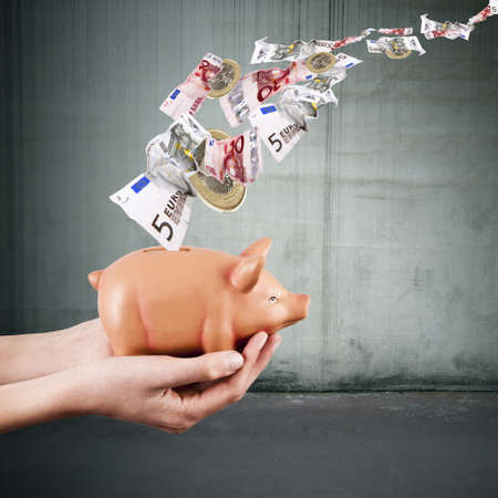 hands holding pink pig piggy bank, economics and financeの写真素材