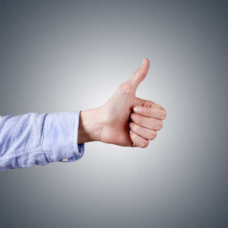 hand with thumb raised as a sign of success