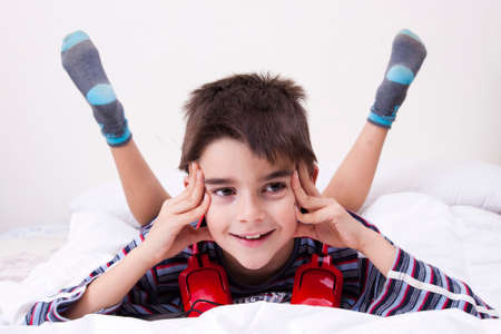 boy lying in the room with music headphones