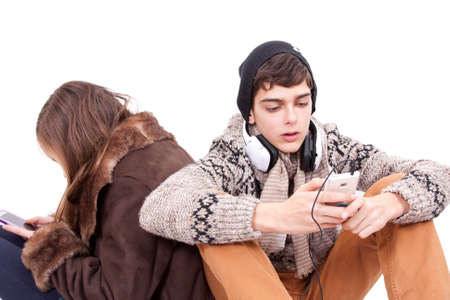 Teen chatting with mobile phoneの写真素材
