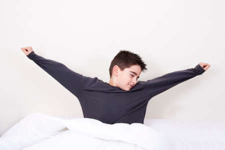 cute little boy with expressions in bedの写真素材