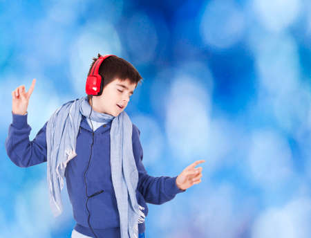 Young dancing with blue background and headphonesの写真素材