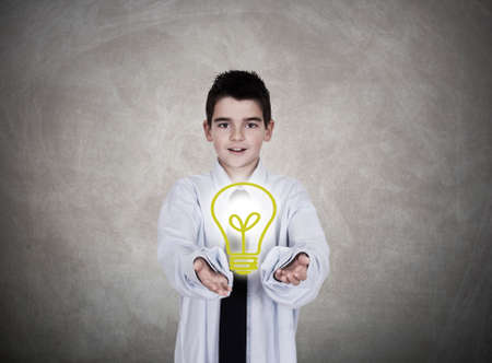 Young boy holding bulb in hand creativity