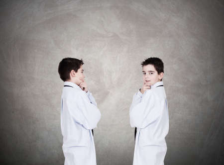 Young boys wearing business clothes talking and discussingの写真素材