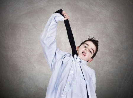 young man in business clothes with tie drowningの写真素材