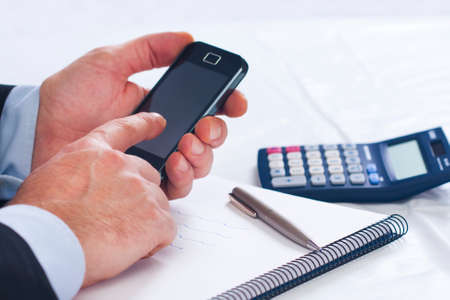 Businessman working in the office with mobile phone