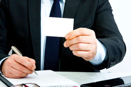 businessman with business card in foreground の写真素材