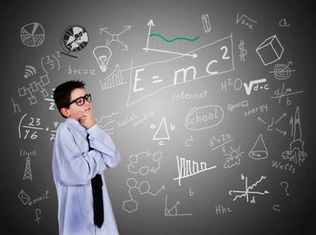 child in clothing business at the blackboard with formulas