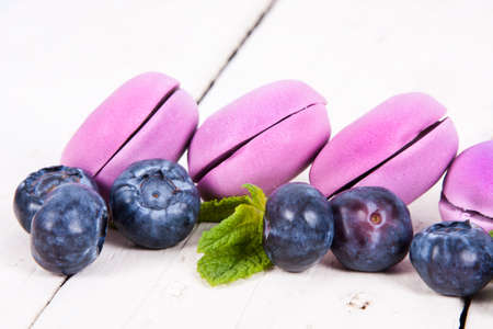 macaroons stacked on white wooden background, cupcakesの写真素材