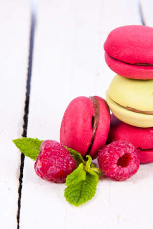 macaroons stacked on white wooden background, cupcakesの写真素材