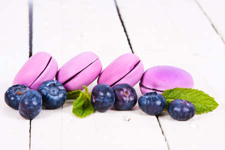 macaroons stacked on white wooden background, cupcakesの写真素材