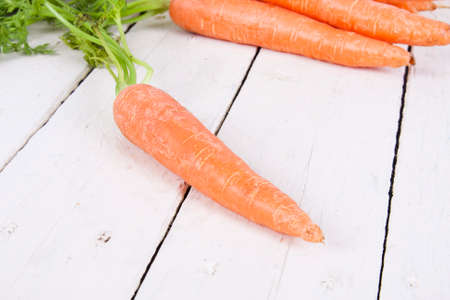 stacked fresh carrots on white background, vegetablesの写真素材