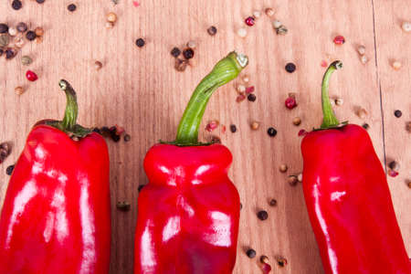 red peppers on wooden background fresh vegetablesの写真素材