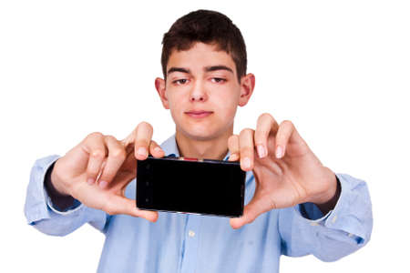 Young boy with phone becoming a self-portraitの写真素材