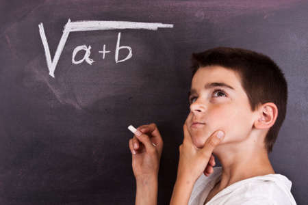 child in school blackboard with mathematical formula