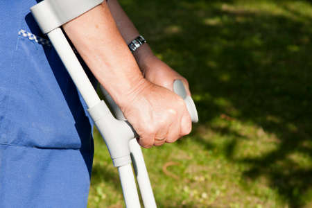 closeup of old hands with crutchesの写真素材