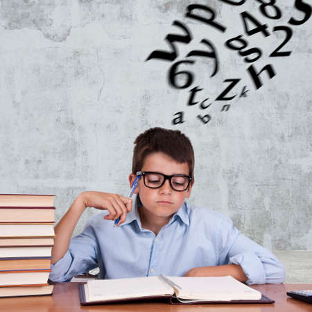 child at the table with books from school