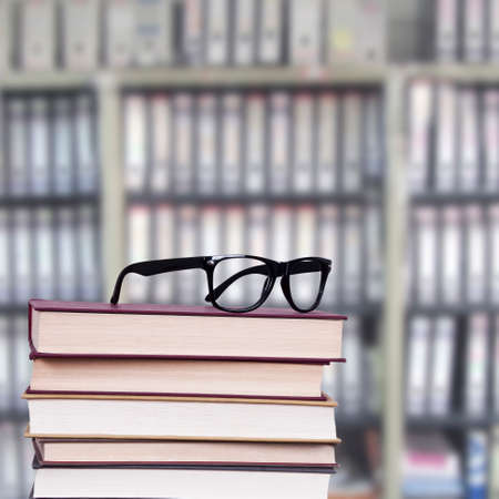 glasses above the stacked books, business and objects