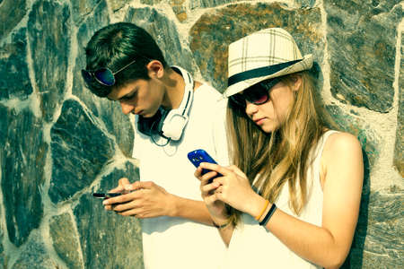 young couple in communicating with mobile phoneの写真素材