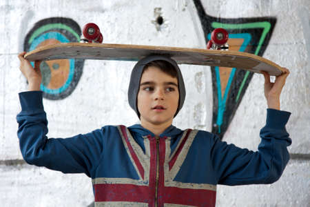a kid with skateboard in the city