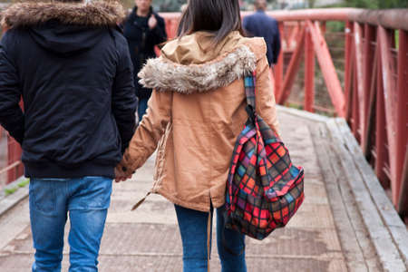 young couple holding hands walkingの写真素材