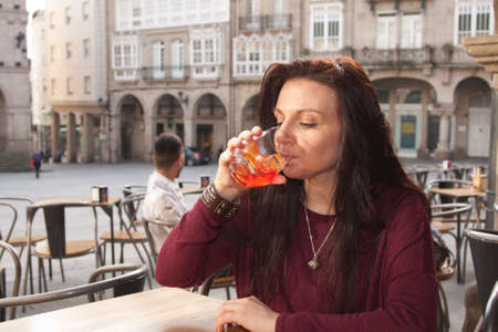 girl taking a drink at the barの写真素材