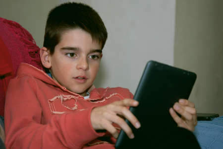 child with mobile tablet at home