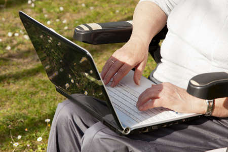 senior woman with computer outdoors