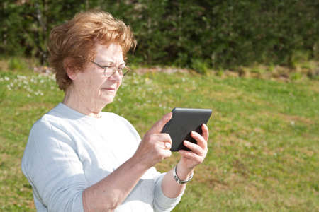elderly woman with computer technologyの写真素材