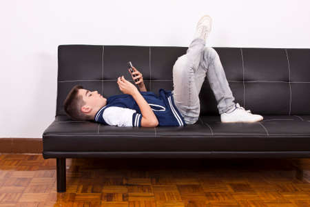 child with mobile phone indoors, technologyの写真素材