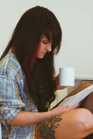 Girl playing guitar indoors, lifestyle