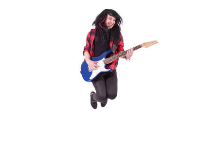 young man jumping with electric guitarの写真素材