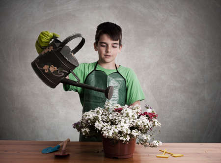 child preparing garden plantsの写真素材