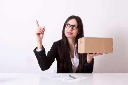 business woman pointing with cardboard boxesの写真素材