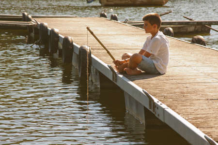boy fishing in the riverの写真素材