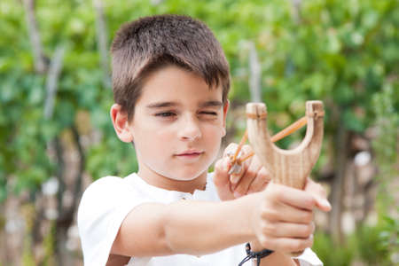 boy with slingshot outdoorsの写真素材