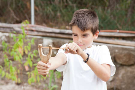 boy with slingshot outdoorsの写真素材