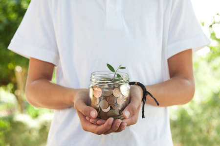hands with coins saving conceptの写真素材