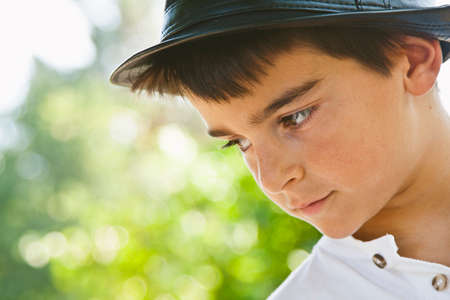 portrait of boy with hat outdoorsの写真素材