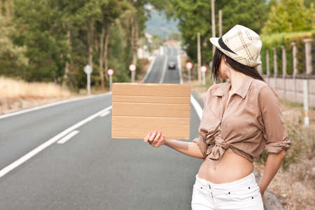 poster girl hitchhiking on the roadの写真素材
