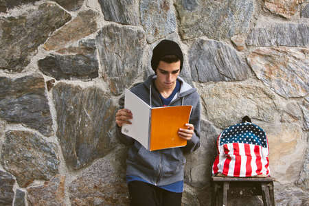 young woman with book and school bag
