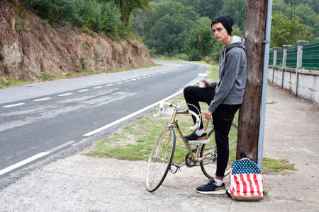 Teen with bike outdoors