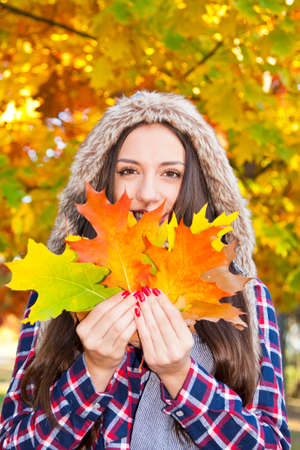 young girl with autumn leavesの写真素材